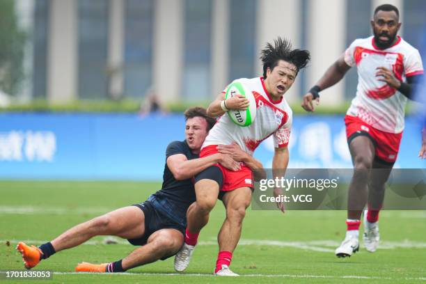 Team Japan competes against Team Hong Kong in the Rugby Sevens - Men's Semifinal on day three of the 19th Asian Games at Hangzhou Normal University...