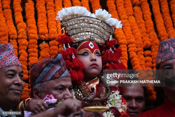 Girl revered as living goddess 'Kumari' is carried by devotees during a procession on the occasion of the last day of the 'Indra Jatra' festival in...