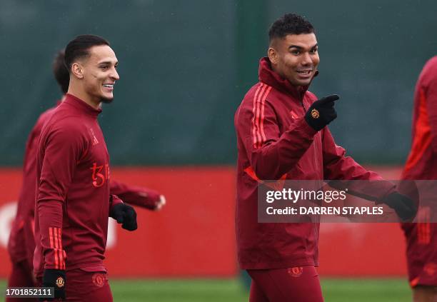 Manchester United's Brazilian striker Antony and Brazilian midfielder Casemiro attend a training session at the Carrington Training Complex in...