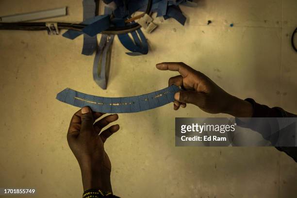 Charles Mwangi, weather station operator, holds paper for a device for measuring hours of sunlight at the Meteorological Station on Mount Kenya on...