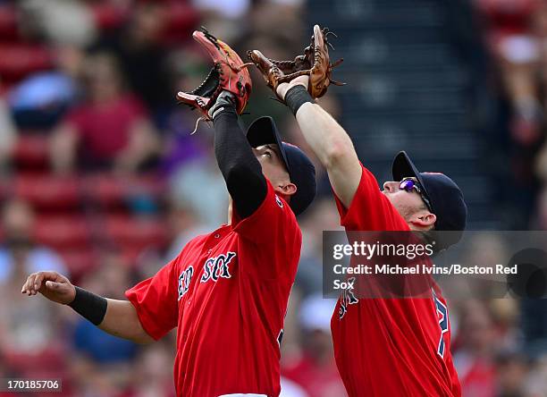 Jose Iglesias and Stephen Drew track a pop fly against the Los Angeles Angels of Anaheim in the ninth inning on June 8, 2013 at Fenway Park in...