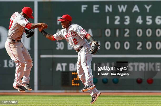 Howie Kendrick and Erick Aybar of the Los Angeles Angels of Anaheim celebrate a 9-5 win over the Boston Red Sox during the first game of a...