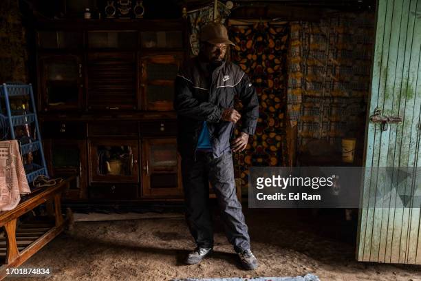 Porter Johana Macharia stands in his home after coming from the mountain in Gitinga Village, where 60% of the men work as mountain porters accounting...