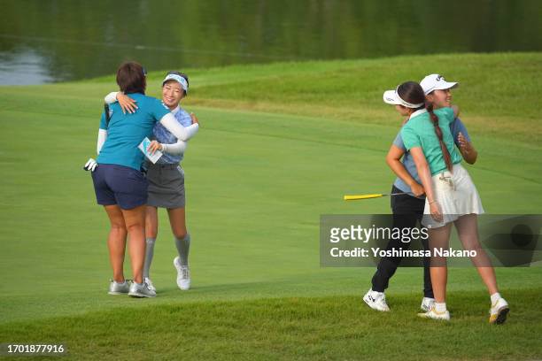 Maiko Wakabayashi, Mana Shinozaki, Seira Oki and Riko Inoue of Japan embrace after holing out on the 18th green during the first round of Sky Ladies...