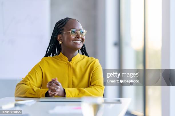smiling young mixed race businesswoman looking away - businesswear stock pictures, royalty-free photos & images