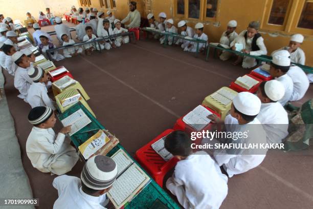 Afghan children read the holy Koran at a madrassa or an Islamic school in Jalalabad on October 2, 2023.