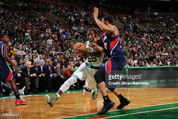 Terrence Williams of the Boston Celtics drives to the basket against Mike Scott of the Atlanta Hawks on March 29, 2013 at the TD Garden in Boston,...