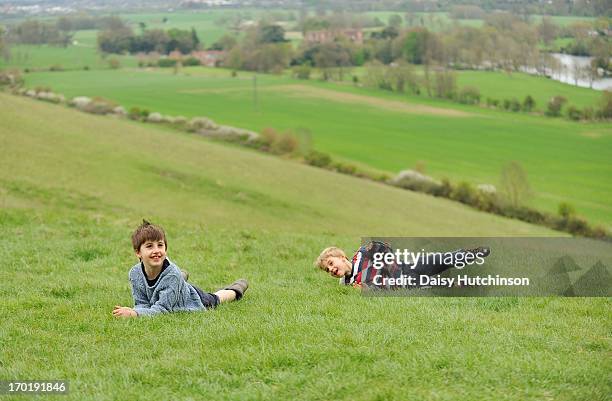 boys on a hillside - kid looking down stock pictures, royalty-free photos & images