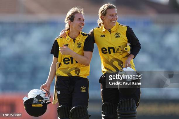 Chloe Piparo and Mathilda Carmichael of Western Australia walk from the field after winning the WNCL match between Western Australia and Victoria at...