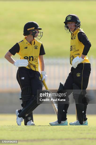 Chloe Piparo and Mathilda Carmichael of Western Australia talk between overs during the WNCL match between Western Australia and Victoria at the...