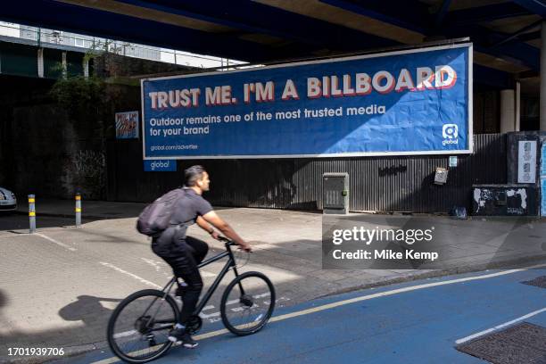 Billboard poster promoting the usage of billboards as trusted advertising space reads ' trust me, I'm a billboard' by Global Media Group Services...