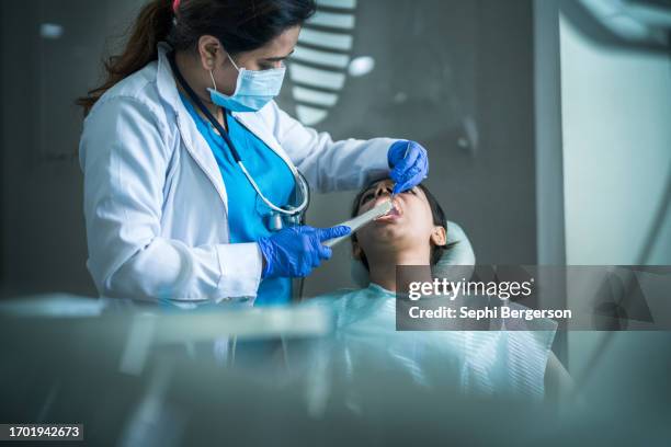 dentist using technology - vulling tandartsapparatuur stockfoto's en -beelden