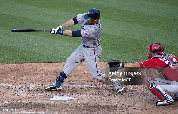 Minnesota Twins catcher Ryan Doumit follows through on a hit to center field to drive in catcher Chris Herrmann for the winning run during the 11th...