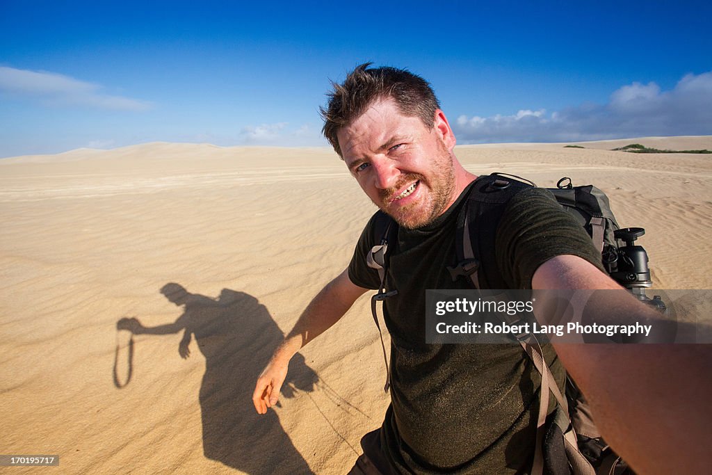 Adventure photographer self portrait in sand dunes