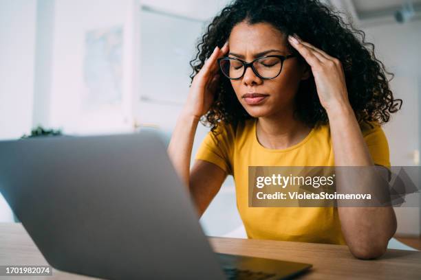 overworked young businesswoman in the office. - struggle stock pictures, royalty-free photos & images