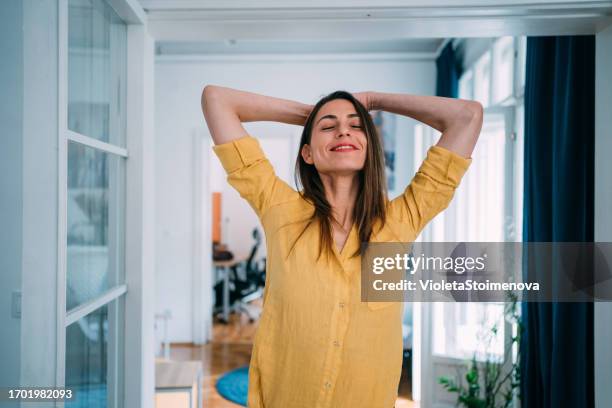woman relaxing at home. - woman breathe stock pictures, royalty-free photos & images