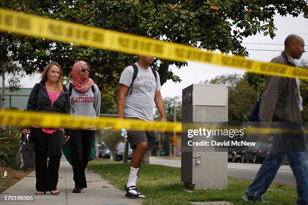 Students leave Santa Monica College, which remains closed for a second day as investigators gather evidence from crime scenes, after picking up...