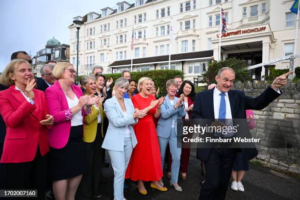 Sir Ed Davey, leader of the Liberal Democrats, walks to the conference with MP's and parliamentary candidates at Bournemouth International Centre on...