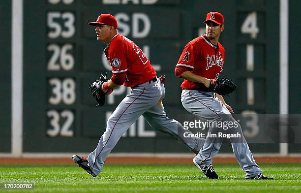 Brad Hawpe and Mike Trout of the Los Angeles Angels of Anaheim cannot make the catch on a ball hit by David Ross of the Boston Red Sox in the 5th...