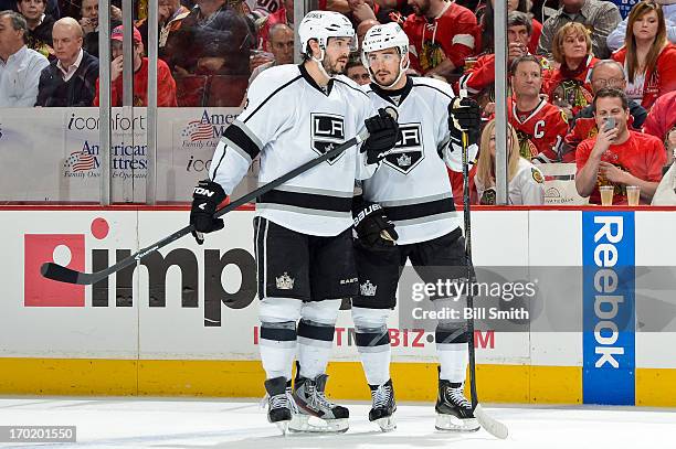 Teammates Drew Doughty and Slava Voynov of the Los Angeles Kings talk in Game Five of the Western Conference Final against the Chicago Blackhawks...