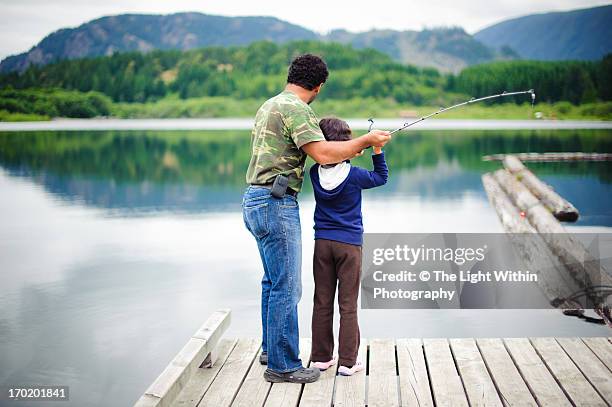 dad teaching a child to fish - cowichan bay stock pictures, royalty-free photos & images