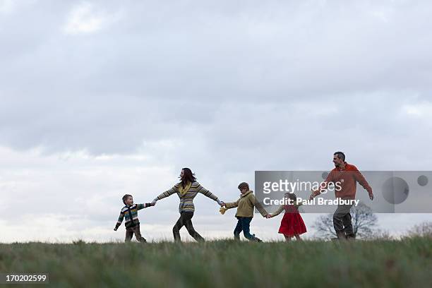 family walking outdoors in autumn - medium group of people stock pictures, royalty-free photos & images