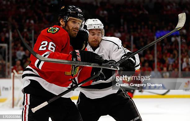 Michal Handzus of the Chicago Blackhawks fights for position against Trevor Lewis of the Los Angeles Kings during Game Five of the Western Conference...