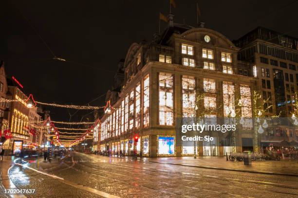 amsterdam damrak shopping street with christmas decorations - amsterdam christmas stock pictures, royalty-free photos & images