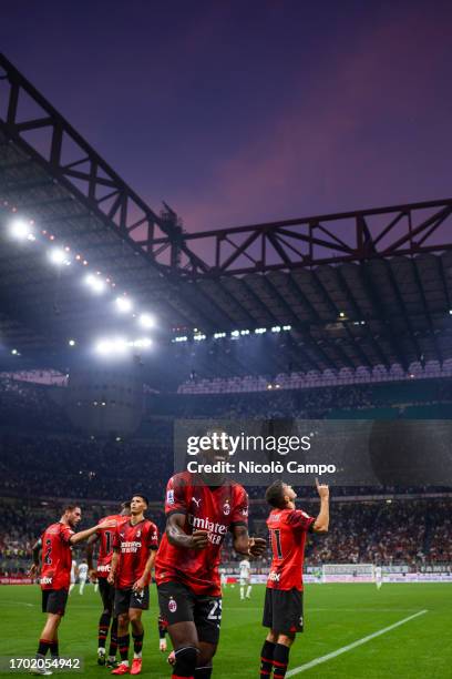 Christian Pulisic of AC Milan celebrates with Fikayo Tomori of AC Milan after scoring the opening goal when the sky over Giuseppe Meazza stadium is...