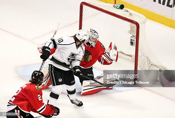 The Los Angeles Kings' Mike Richards puts the tying goal past Chicago Blackhawks goalie Corey Crawford with less than a minute remaining during the...