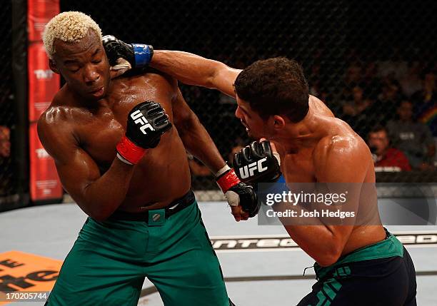 Leonardo Santos punches William "Patolino" Macario in their welterweight fight during the UFC on FUEL TV event at Paulo Sarasate Arena on June 8,...