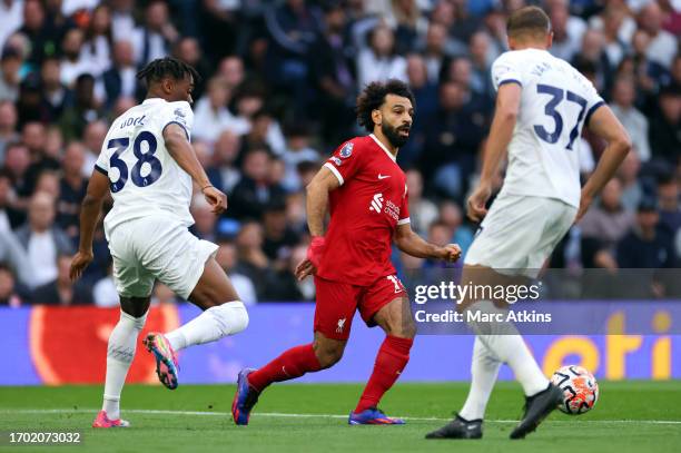 Mohamed Salah of Liverpool in action with Destiny Udogie and Micky van de Ven of Tottenham Hotspur during the Premier League match between Tottenham...