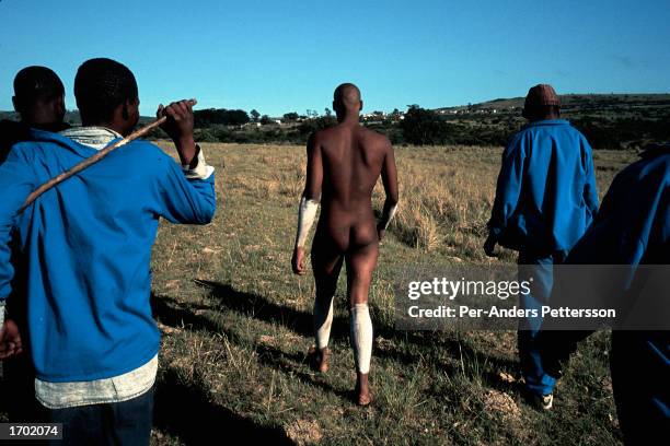 Luxolo Mkwelo a Xhosa boy goes to wash off the clay from his body, which will symbolize the start of a new life, as he goes through the traditional...