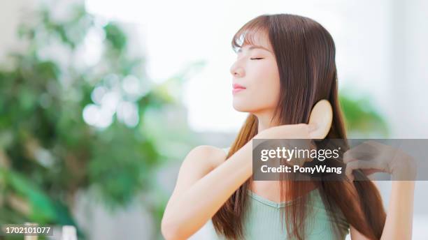 asian happy woman brush hair - hair comb stock pictures, royalty-free photos & images