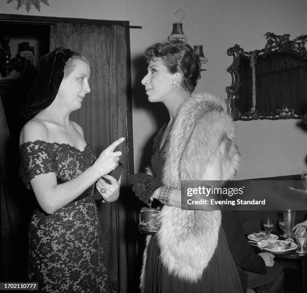 Actresses Diana Wynyard , left, and Miriam Karlin during a social event, February 19th 1957.