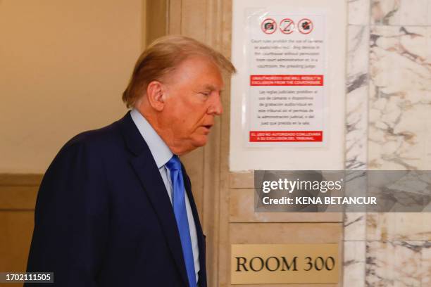 Former US president Donald Trump arrives to the court room following a break at the New York State Supreme Court on the first day of his civil fraud...