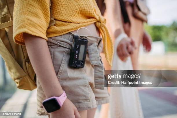cute schoolgirl with a insulin pump traveling by bus to school. - childhood diabetes stock pictures, royalty-free photos & images