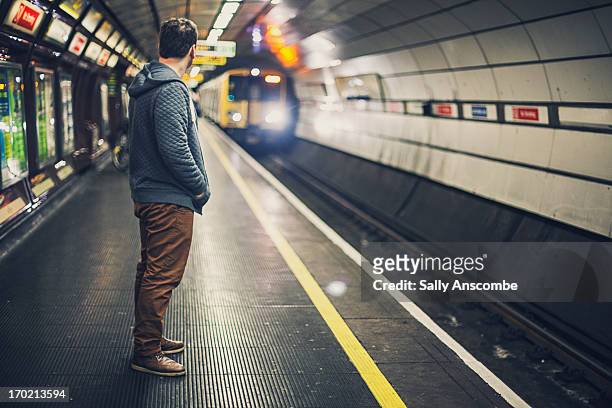 man waiting for a train - waiting foto e immagini stock