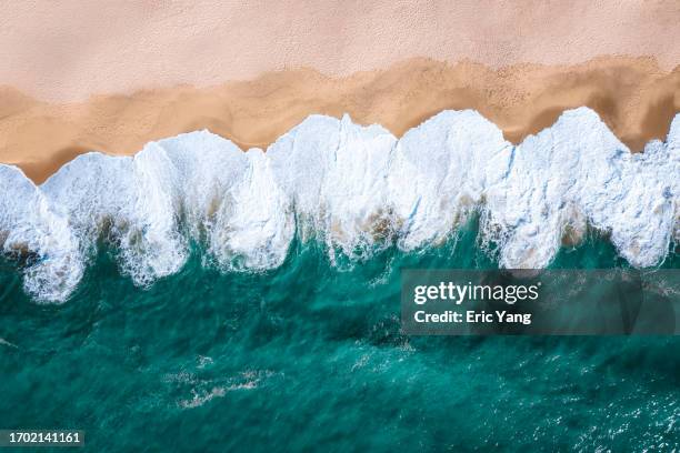 white waves washing the beach - brisbane beach stock pictures, royalty-free photos & images