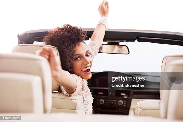 cheerful african-american woman in convertible car. - car white background stockfoto's en -beelden