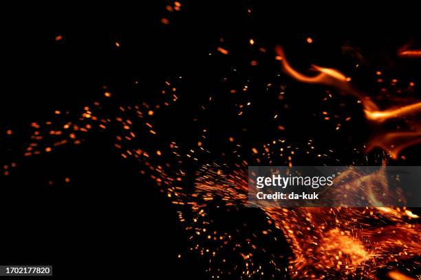 burning fire with sparks on black background - igniting stock pictures, royalty-free photos & images