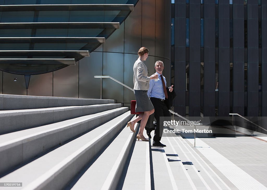 Business people walking down steps