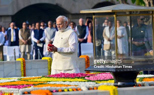 Prime Minister Narendra Modi pays tribute to Mahatma Gandhi on his 154th birth anniversary at Rajghat, on October 2, 2023 in New Delhi, India....