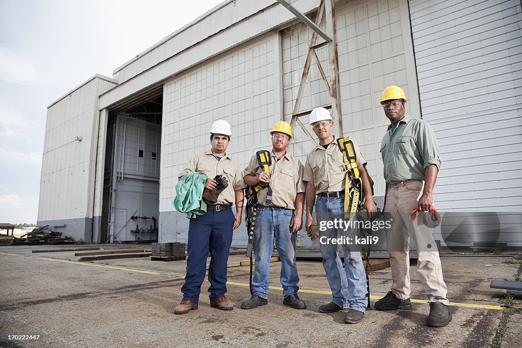 Team of construction workers with harnesses