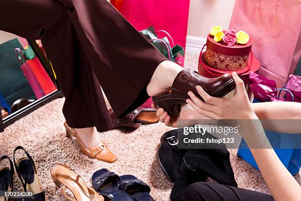 konsum. frau einkaufen und versuchen, auf schuhe - ladies clogs stock-fotos und bilder