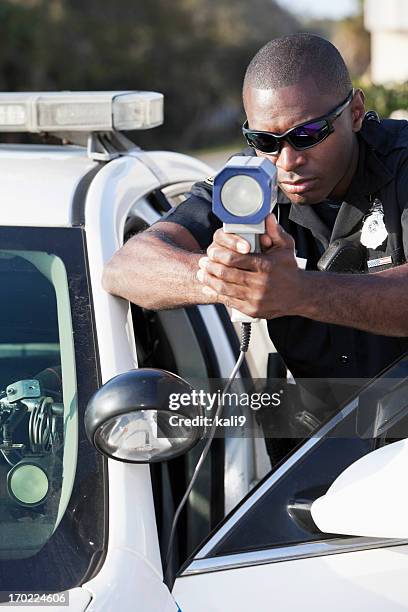 police officer with radar gun - lasergun stockfoto's en -beelden