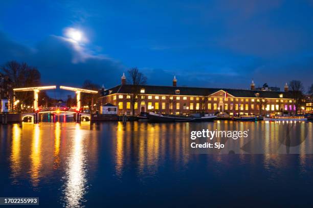 hermitage amsterdam h'art museum at the amstel river during winter - hermitage amsterdam museum stock pictures, royalty-free photos & images