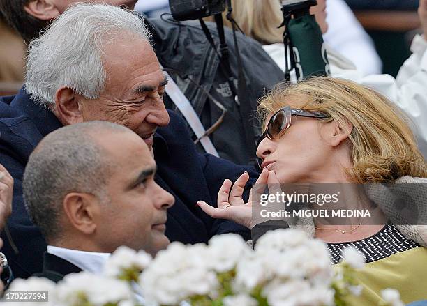 Former IMF chief Dominique Strauss-Kahn and his partner, Media Marketing Executive Myriam L'Aouffir attend the 2013 French tennis Open final at the...