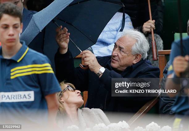 Former IMF chief Dominique Strauss-Kahn and his partner, Media Marketing Executive Myriam L'Aouffir attend the 2013 French tennis Open final at the...