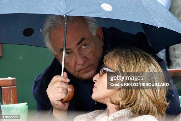 Former IMF chief Dominique Strauss-Kahn and his partner, Media Marketing Executive Myriam L'Aouffir attend the 2013 French tennis Open final at the...